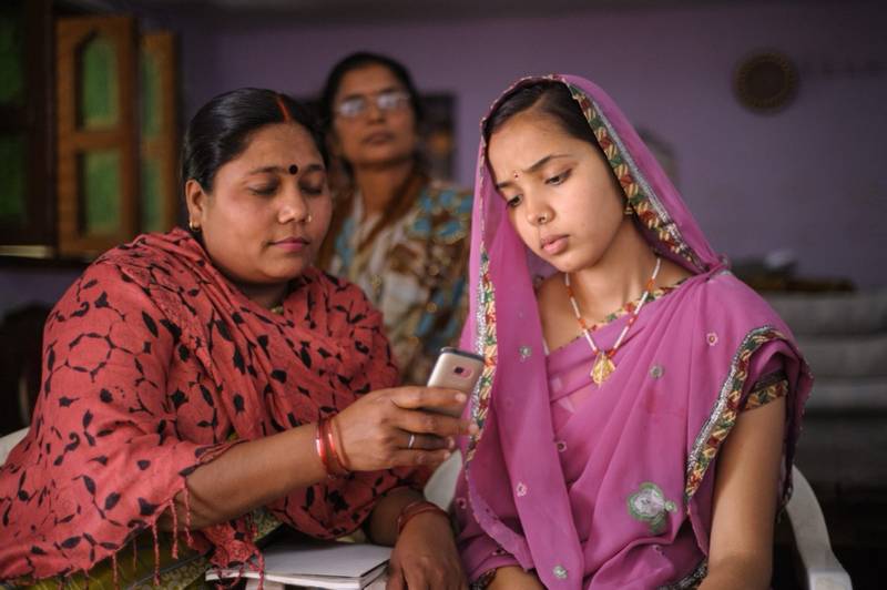 Community health workers reviewing tasks together in the field