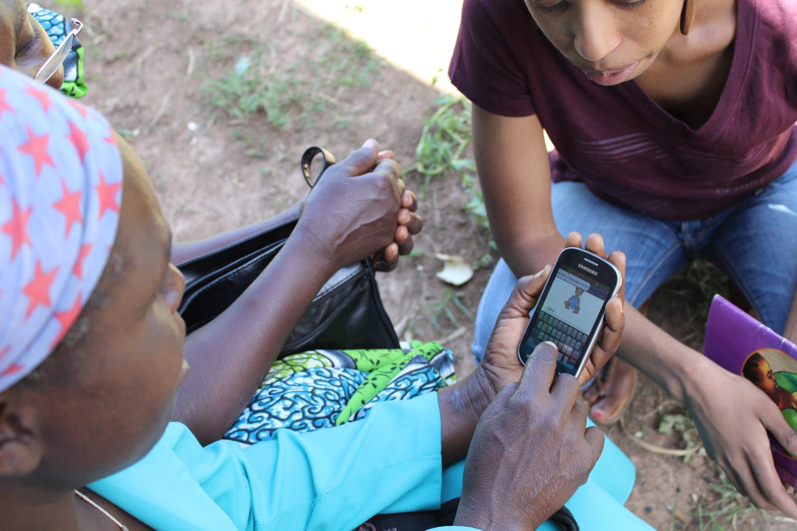 A community health worker reviewing the design of a mobile data collection app