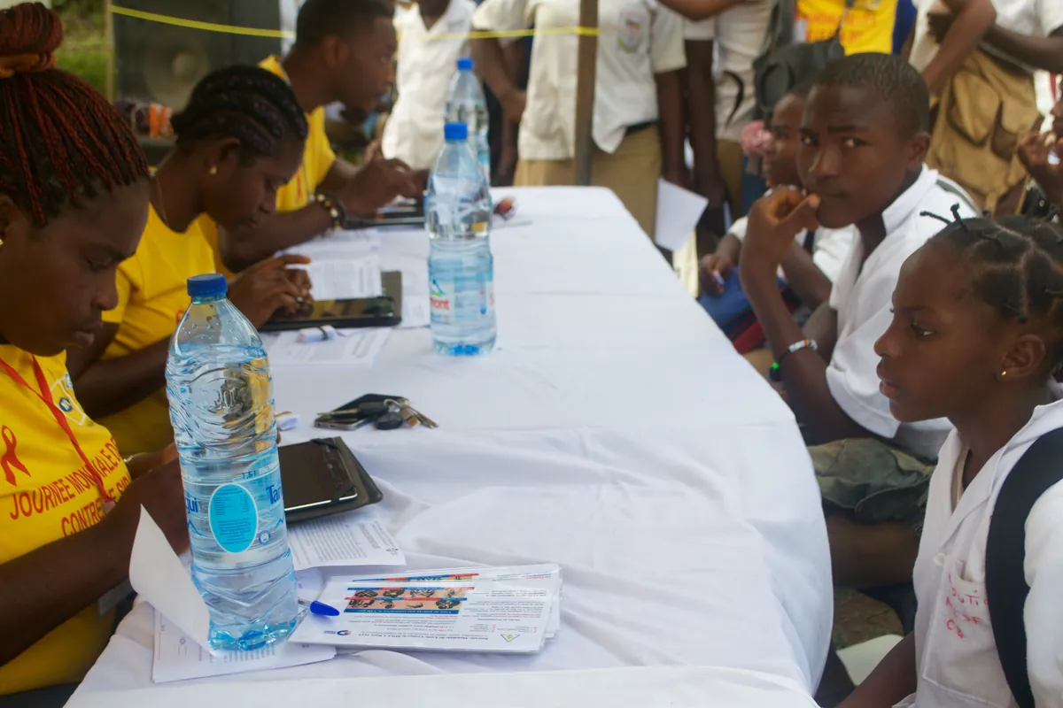 Campaign recorders registering secondary school students at a long table during the free HIV Testing and Counseling campaign