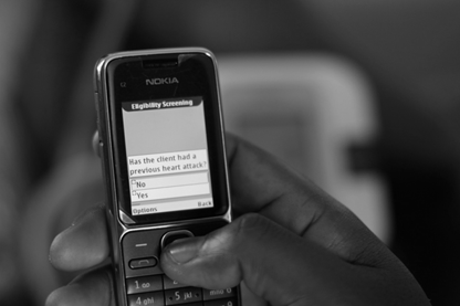 A mobile phone showing the CommCare cardiovascular disease eligibility screening question
