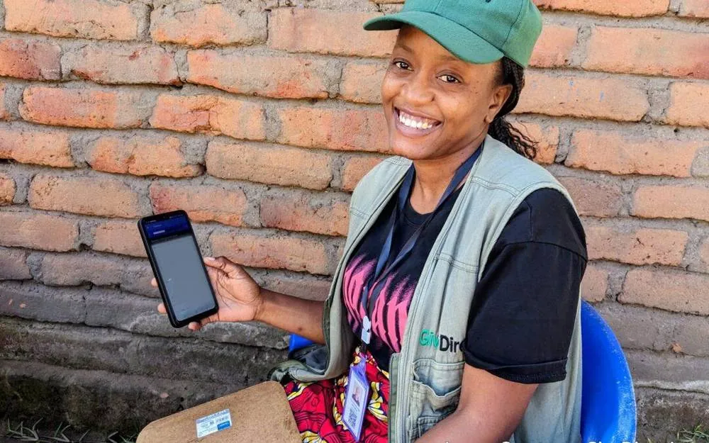 GiveDirectly field officer using CommCare on a smartphone