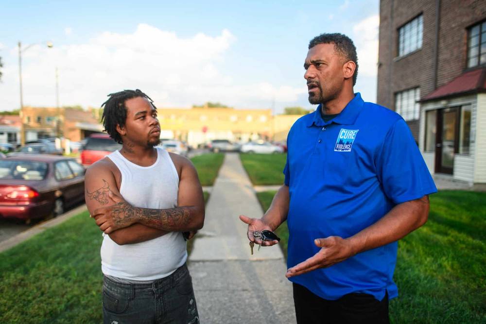 Cure Violence Global outreach worker speaking with a participant