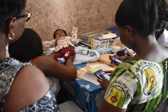 Health workers running a digitized national malaria net distribution campaign
