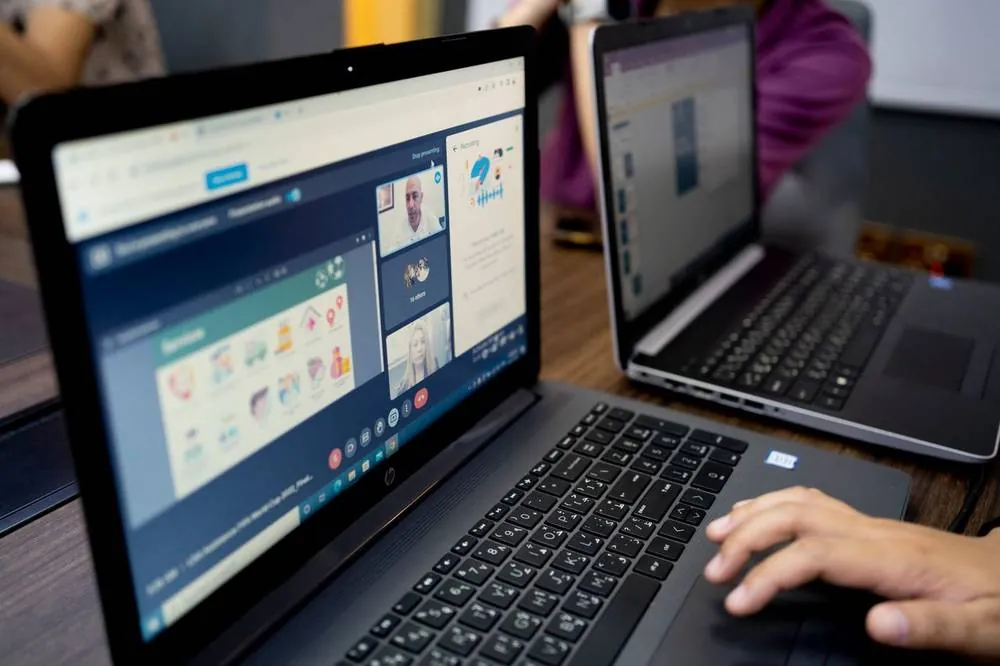 A Dimagi team member supporting a partner over a video call while building a CommCare app
